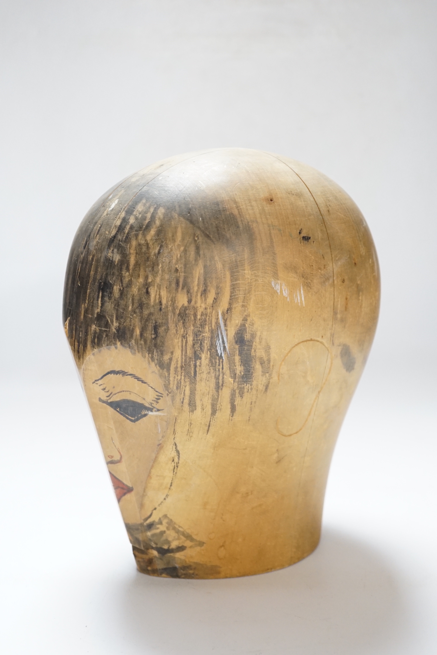 A Hatter's block with hand painted face, stamped Zurich to the base, 25cm high